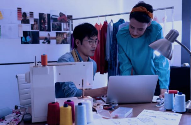 Photo of two people in the garment industry talking about transactions